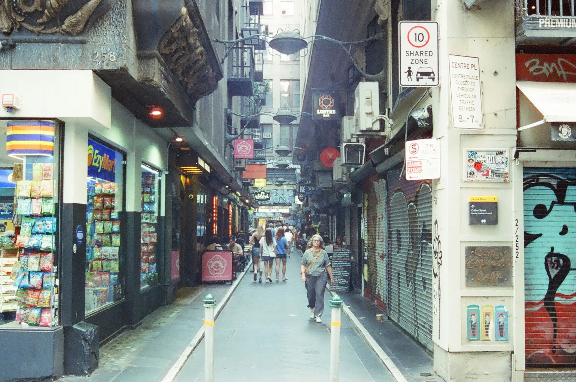 Centre Place laneway in Melbourne's CBD, lined with small shops and cafés, with shoppers walking between them